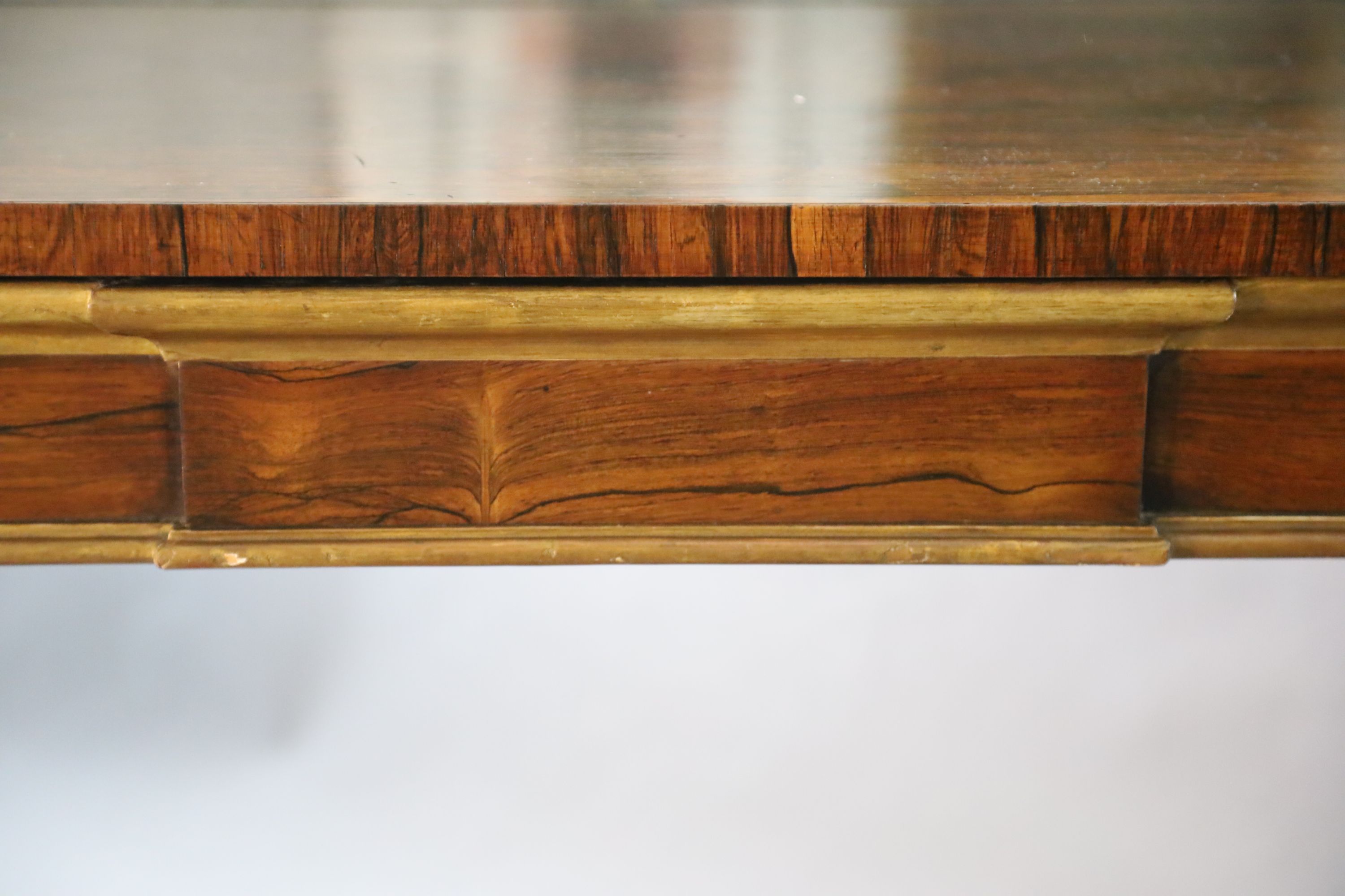 A pair of William IV parcel gilt rosewood console tables, W.8ft 2in. D.1ft 4in. H.4ft 4in.